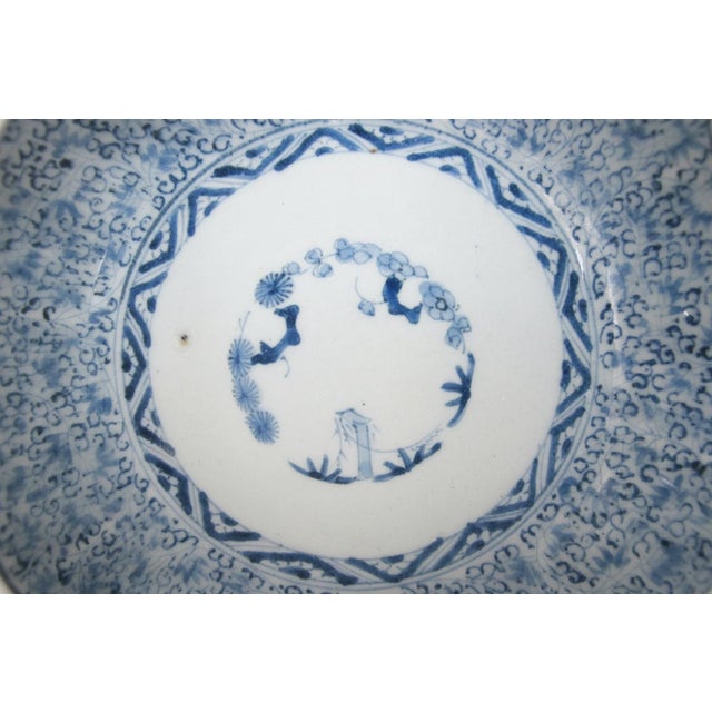 Sweet Japanese Imari porcelain bowl with scalloped rim. Blue and white porcelain with floral and bamboo design. Measures...