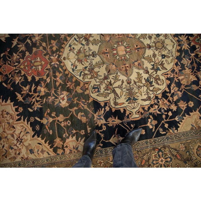 :: Double concentric medallion with interior floral blossom in polychrome fill adorned by a double tiered finial at either...