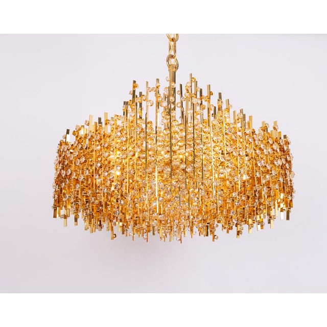 Exceptional gilded chandelier by palwa, dating from the 1970s. This striking fixture features a dense, architectural...