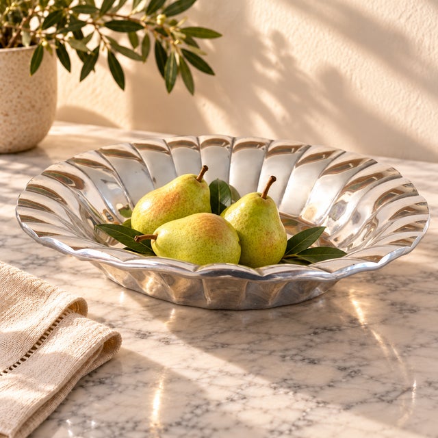 A generously scaled vintage Mexican cast-aluminum serving bowl attributed to Old Town Imports. Modeled as a stylized...