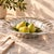 A generously scaled vintage Mexican cast-aluminum serving bowl attributed to Old Town Imports. Modeled as a stylized...