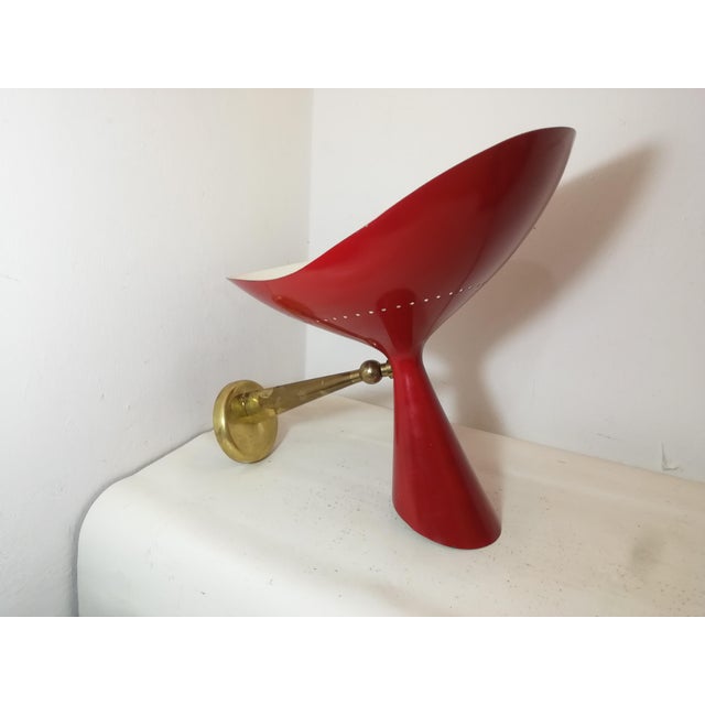 Wall lamp designed by Oscar Torlasco and produced by Lumen in the 1950s. Model AD/1. Brass arm and double-cone diffuser in...