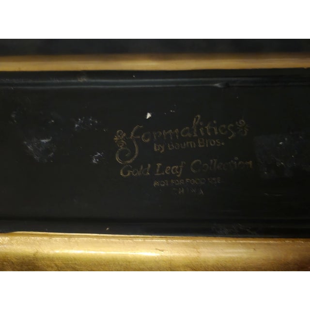 A beautiful narrow gold leaf trinket tray by Baum Brothers. The tray features a pretty delicate painted humming bird with...