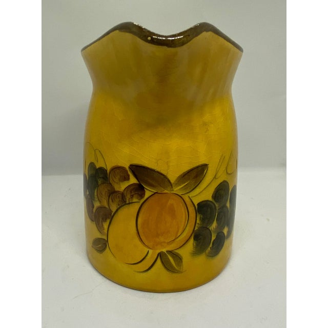 Bright and vivid Midcentury Pottery Pitcher with Hand Painted Fruit Design and Mustard Golden Brown Color. It was made in...