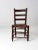 This antique splint weave seat chair features a rustic wooden frame with a classic ladder-back design. The seat is...