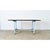 An antique French industrial work table/kitchen island from the early 20th century, whose robust design is a practical...