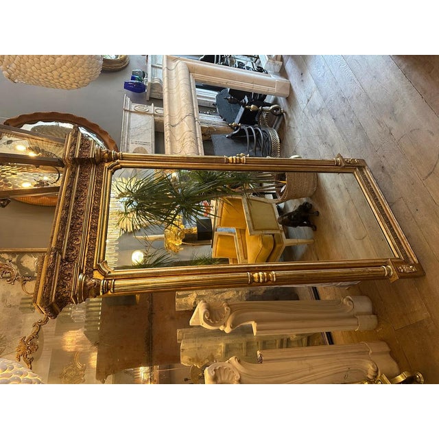 A tall gold gilt and gesso English Regency Pier mirror glass. Very well and profusely decorated pediment, with columned...