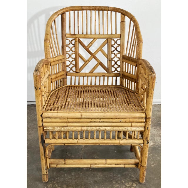 Large vintage Chinese Chippendale style bamboo armchair with solid fretwork panels framing detailed angled back. Caned...