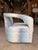 Contemporary swivel accent chair upholstered in a striking abstract fabric featuring layered shades of sky blue, soft...