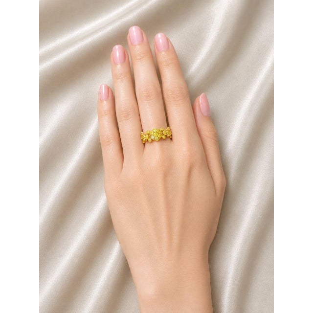 Beautiful 14K yellow gold eternity wedding band featuring numerous brilliant round yellow diamonds totaling 3.5 carats....