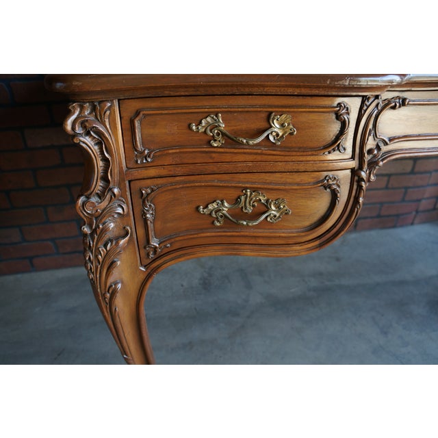 Remarkable French Provincial writing desk . Crafted of walnut with intricately carved details at the corners, perfectly...