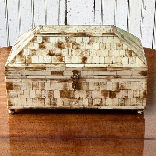 This large-scale Hollywood Regency style tessellated horn and bone inlay vanity chest is a stunning statement piece....