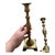 A pair of solid brass candlesticks in a neoclassical/Colonial Revival style in a baluster style with a square footed base....