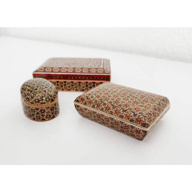 Collection of three mid-20th century handmade micro mosaic boxes crafted of very fine inlay arranged in geometric...