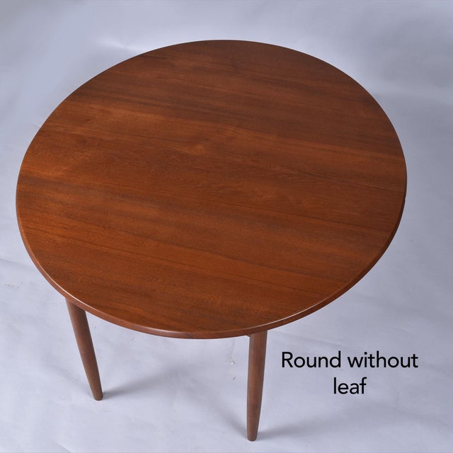 Exceptional, early Mid-Century Modern Danish teak dinging table. This table is unique in that it starts have as a slightly...