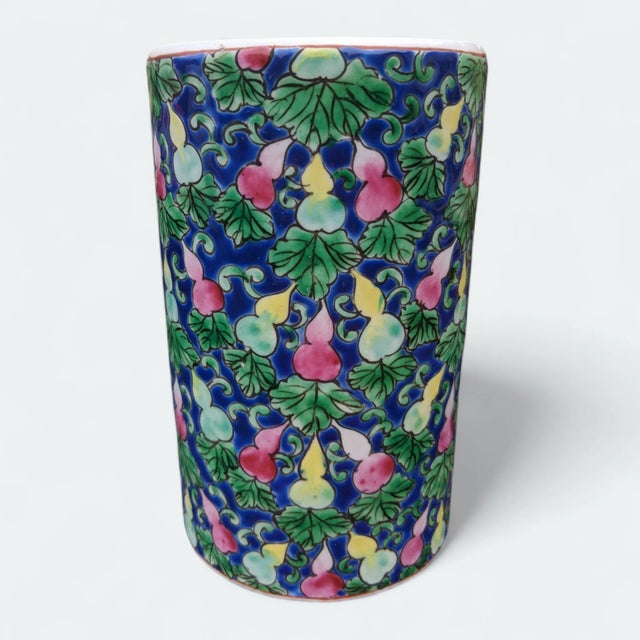 Vintage Chinese Porcelain piece features a hand painted designs of colorful gourds and green leaves against a deep, cobalt...