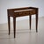 Elegant 1950s vanity table featuring three drawers fitted with square hammered metal pulls. Crafted in dark-stained...