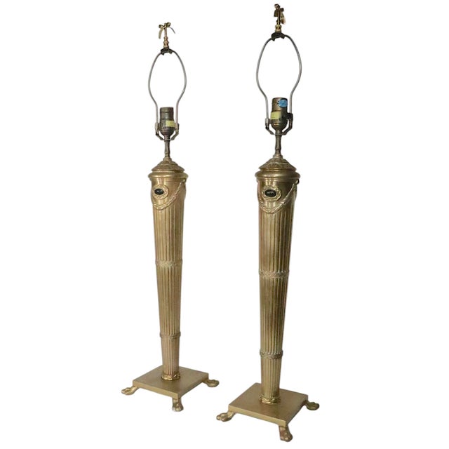Beautiful pair of Neo Classical brass table lamps, by Chapman circa 1997. The lamps feature elegant tapering fluted...