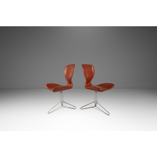 Introducing a rare and limited set of two Modern 'K2' swivel chairs replete with character-rich patina. The K2 chair,...