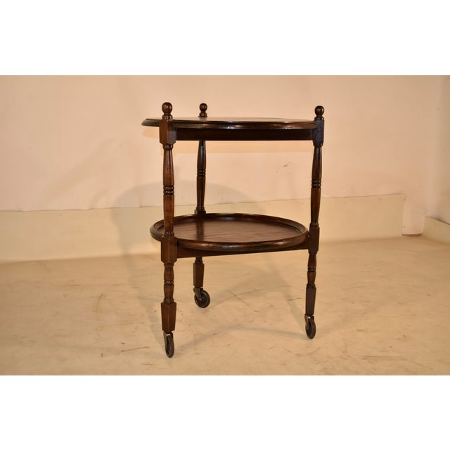 Circa 1920 round oak bar cart from England. This is a very unusual bar cart in that it is round in shape. The top shelf...