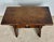 Rustic solid walnut stool or side table featuring hand-carved decorative cut-out details and a sculptural design. The...