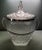 A vintage chrome handled glass ice bucket in a textured pattern with a wider diamond band at the bottom and a smaller...