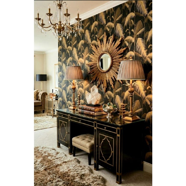 Bring timeless coastal glamour and theatrical elegance to your space with this exquisite pair of vintage gilt table lamps....