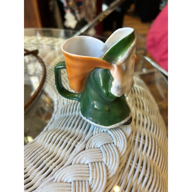 A darling small porcelain Santa pitcher stamped Royal Bayreuth Bavaria on the bottom. This is an unusual color having a...