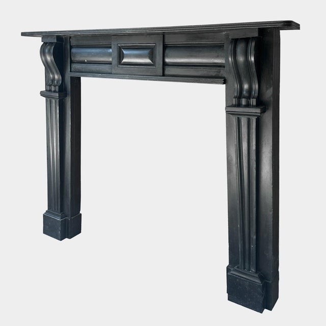 An antique early 19th century Irish Georgian Fireplace executed in Kilkenny Marble. The jambs stood on shaped foot...