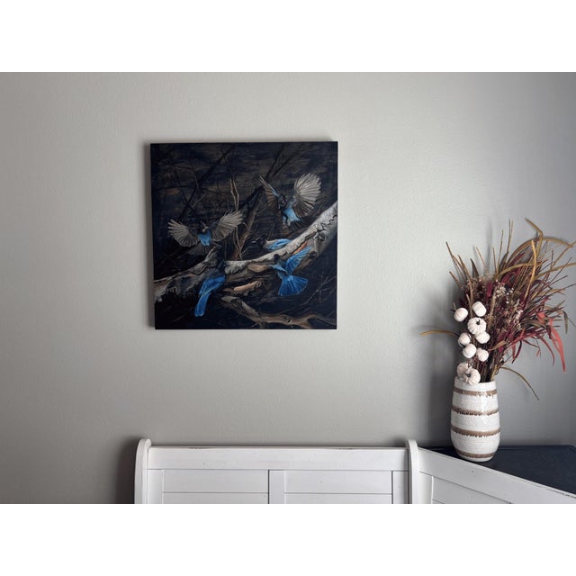 This oil painting captures a dynamic scene of Stellar Jays in mid-flight, their vibrant blue plumage contrasting against...