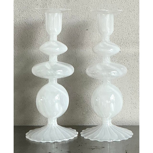 A striking pair of vintage blown glass candlesticks crafted in the style of Murano glassmakers, dating to the 1970s. These...