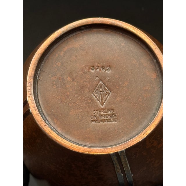 This antique vase from 1912 is a stunning representation of the Arts and Crafts style. Bronze with a Sterling Nouveau...