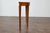 An English Neoclassical walnut demi-lune console table from the 19th century with tapered legs. This English Neoclassical...