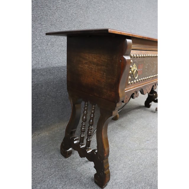 Baroque-style sideboard by Hastings, crafted in walnut with a rich, warm finish. The two drawers feature tooled leather...