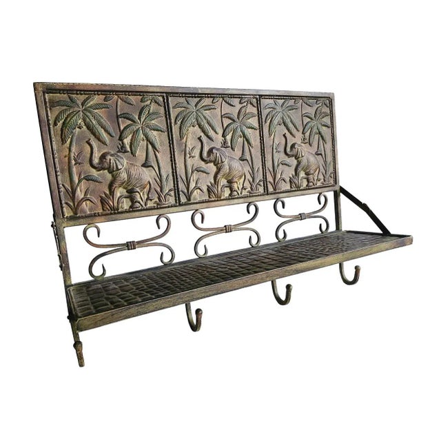 Offered is a smashing vintage brass shelf with 3 panels of embossed elephants and palm trees, a folding shelf with an...
