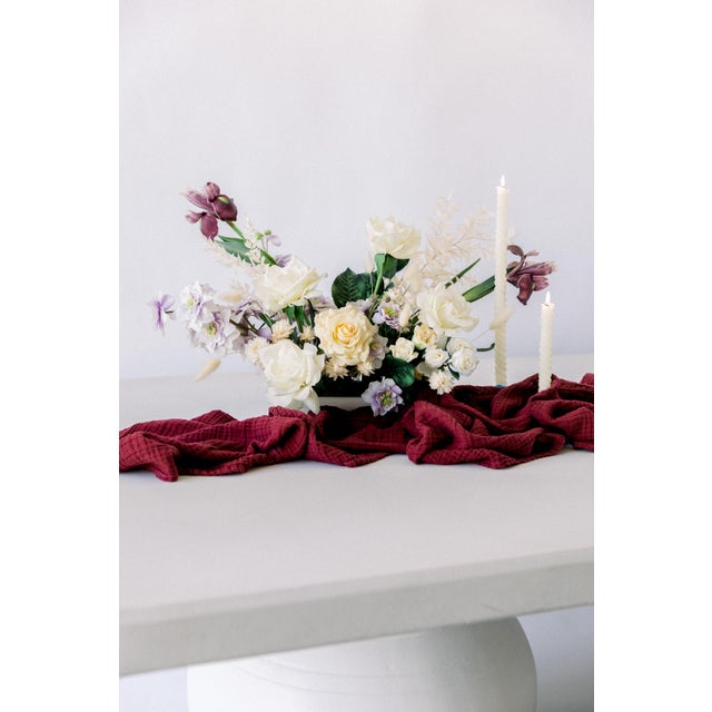 This runner is a 156" x 22" rectangle and made with 100% organic cotton. Perfect for styling down a dinner table.