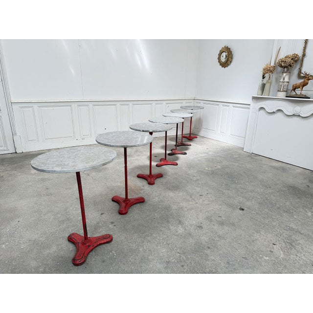 Set of eight 1930s bistro tables from Brasserie Georges in Lyon. Made of marble and cast iron, they are in good condition...