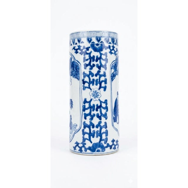 This striking 12-inch porcelain cylinder vase features classic underglaze blue artistry with a traditional Qianlong Nian...