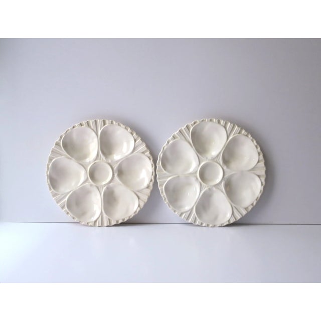 A beautiful pair of all white/off-white porcelain oyster plates, circa early to mid-20th century, Europe. Plates are white...