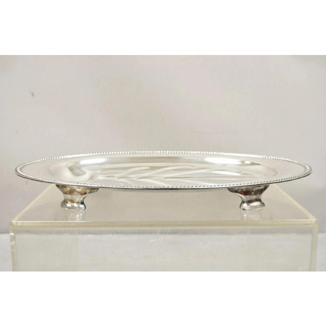 Vintage Community Plate English Regency Style Silver Plated Oval Meat Cutlery Serving Platter. Circa Mid 20th Century....
