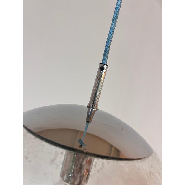 Elegant pendant light from Hustadt Leuchten with a large glass sphere and chrome finish. The fine air bubbles in the glass...