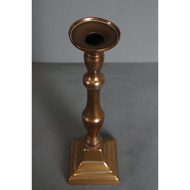 This elegant copper candlestick of large format from the 19th century with a beautiful patina. This large antique copper...