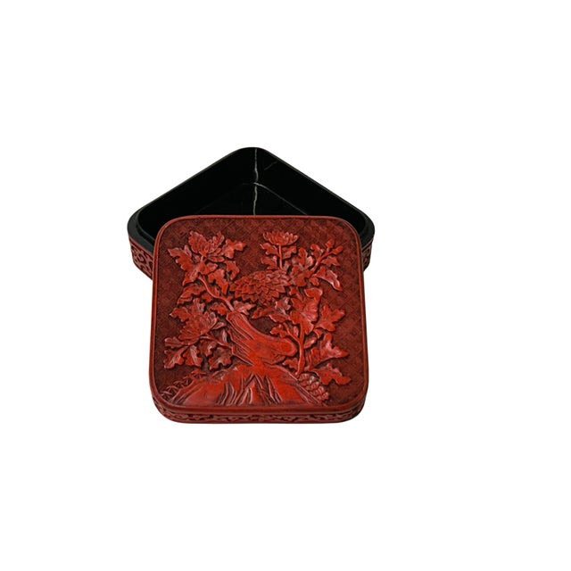 This square, deep-vermilion cinnabar lacquer box features intricate, multi-layered carvings that showcase traditional...