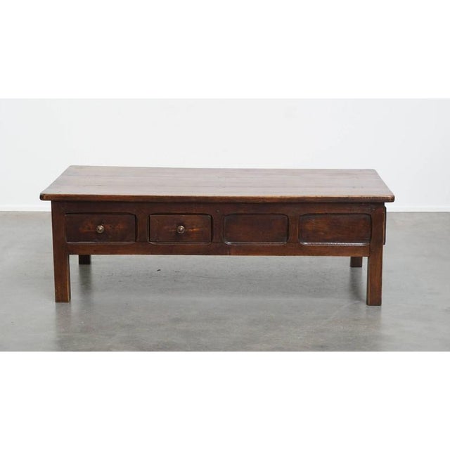 Offered this beautiful and unique antique French fruitwood coffee table with 5 drawers and a beautiful patina. This...