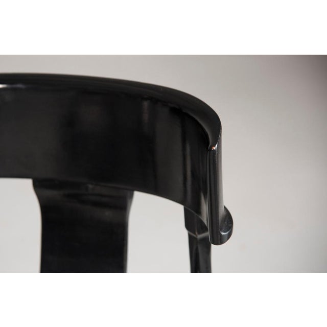 Classic and elegant customizable dining chairs with saber legs, black lacquered wood and black leather seats. Available in...