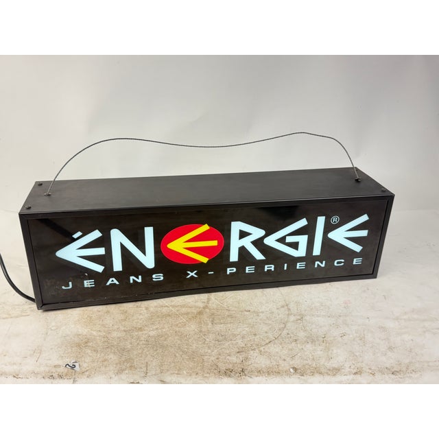 Rare double-sided illuminated sign from the famous streetwear brand Energie, featuring the "Jeans X-perience" logo on a...