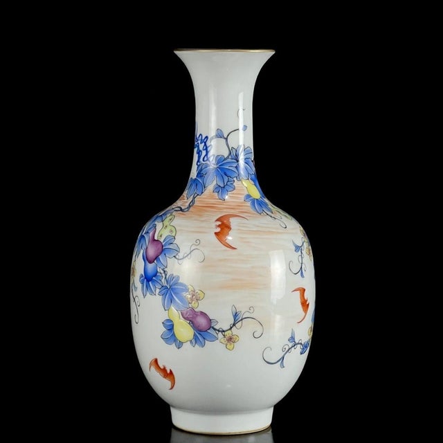 This is a matched pair of elegant vintage porcelain vases featuring a classic flared rim and a gracefully tapering body....