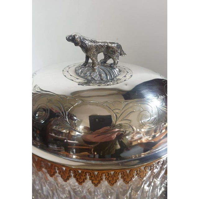 A very nice Victorian cut glass biscuit barrel, standing in a fitted silver plated base. It has a fitted lid with dog...