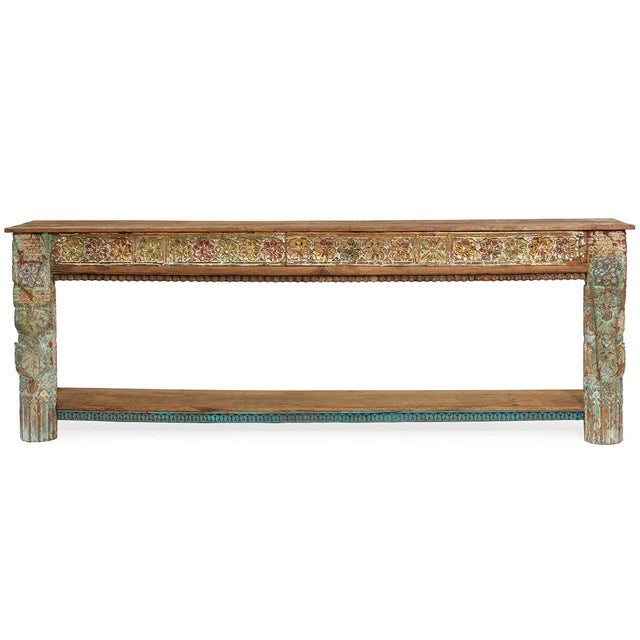 Featuring a unique blend of old and new, this exceptional console table boasts beautifully carved floral patterns on its...
