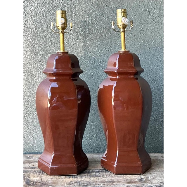 This exquisite pair of vintage ceramic ginger jar table lamps features a rich, glossy brown glaze, offering a seamless...